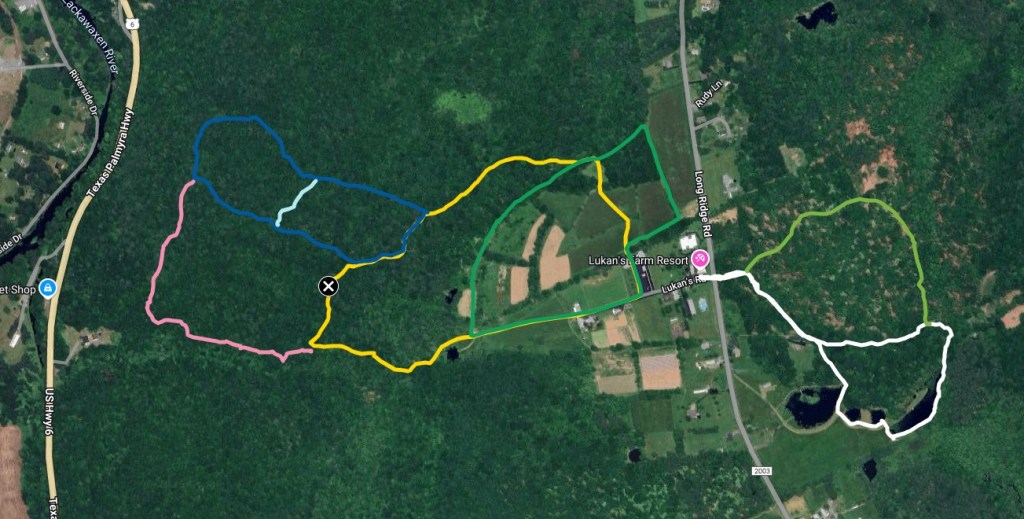 Trail map highlighting various hiking paths in a forested area near Lukan's Farm Resort. Routes are marked in different colors, showcasing available outdoor activities.